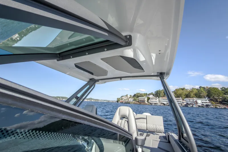 Slide: The Image of 2027 Monterey Elite 27 OB boat interior with lake view and modern design features. - 51