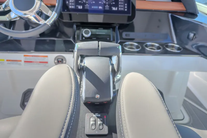Slide: The Image of Cockpit of 2027 Monterey Elite 27 OB boat with steering wheel and controls. - 46