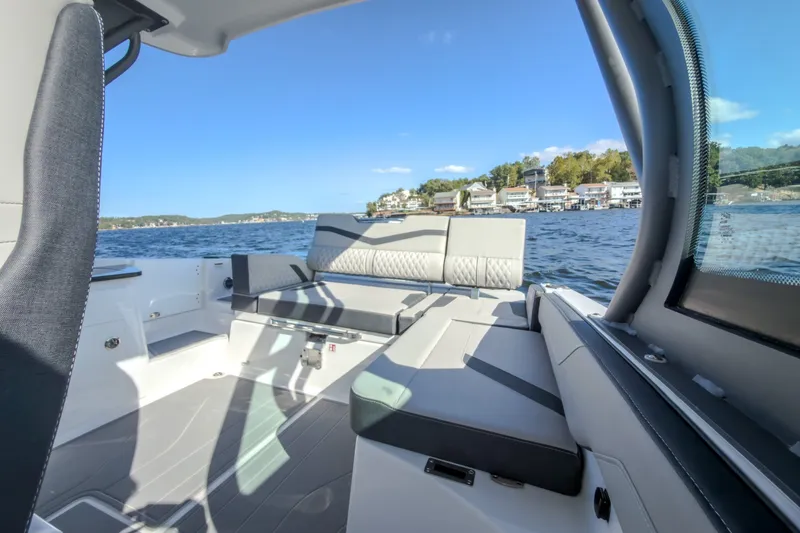 Slide: The Image of Luxurious interior of 2027 Monterey Elite 27 OB boat on a scenic lake. - 52