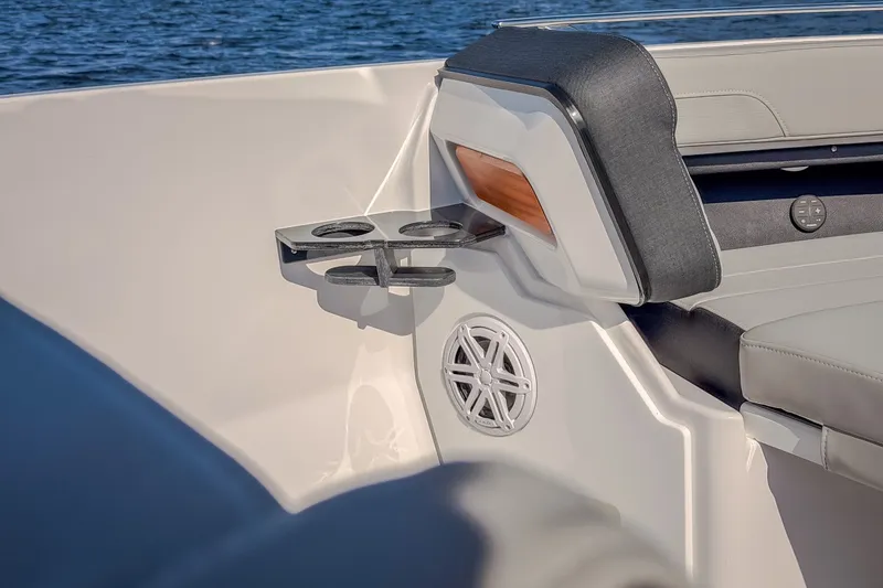 Slide: The Image of Luxury seating and cup holders on 2027 Monterey Elite 27 OB boat, with ocean backdrop. - 56