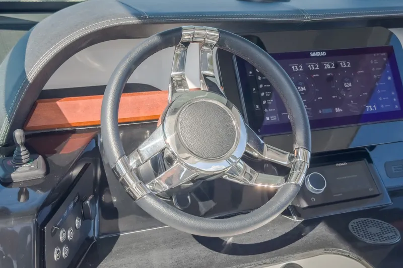 Slide: The Image of Steering wheel and dashboard of 2027 Monterey Elite 27 OB boat with digital display. - 80
