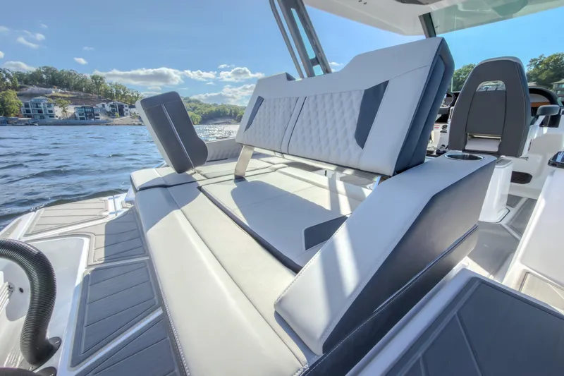 Slide: The Image of Luxurious seating on 2027 Monterey Elite 27 OB boat with scenic lake view. - 24