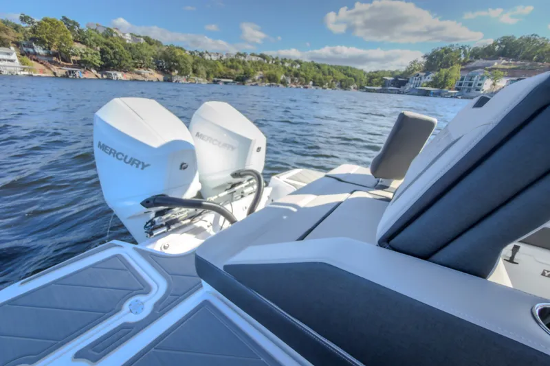 Slide: The Image of 2027 Monterey Elite 27 OB boat with dual Mercury engines on a scenic lake. - 25