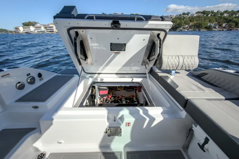 Slide: The Image of 2027 Monterey Elite 27 OB boat with open engine compartment on a lake. - 37