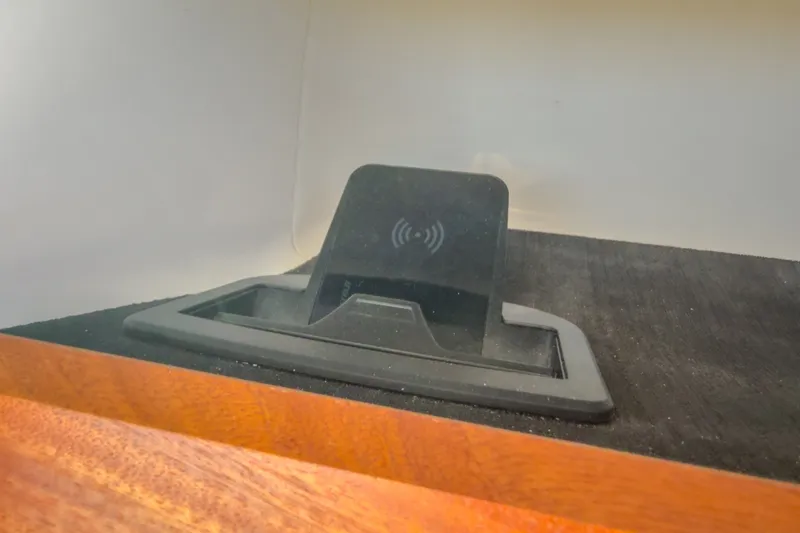 Slide: The Image of Wireless charging pad in 2027 Monterey Elite 27 OB boat interior. - 30