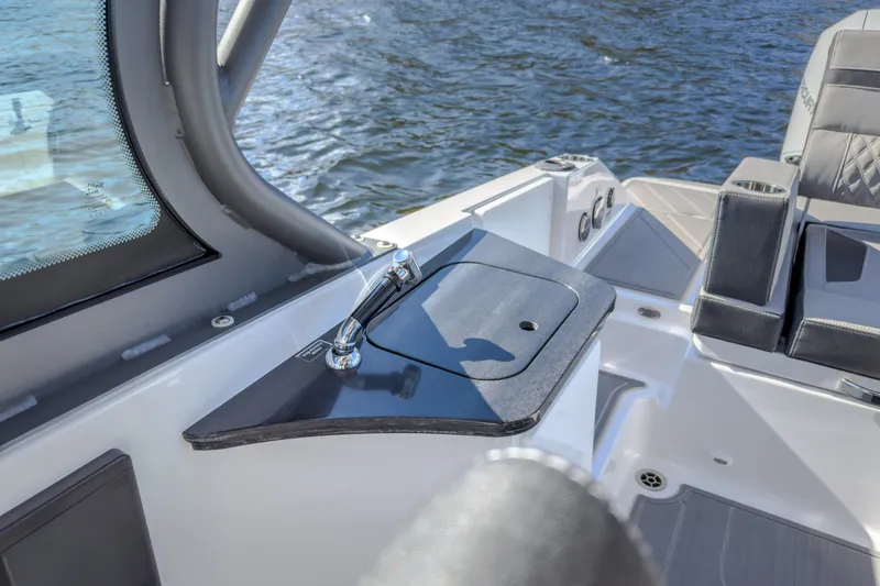 Slide: The Image of 2027 Monterey Elite 27 OB boat interior with sleek seating and modern design on the water. - 69