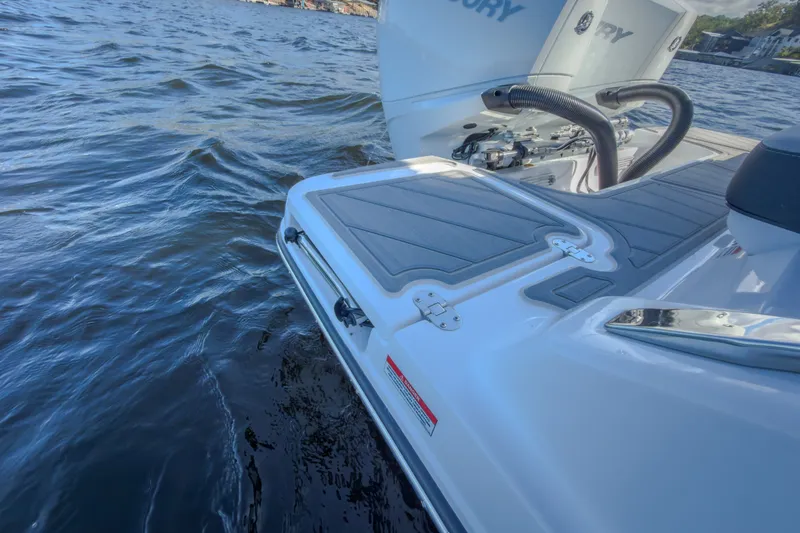 Slide: The Image of 2027 Monterey Elite 27 OB boat on water, showcasing sleek design and engine details. - 20
