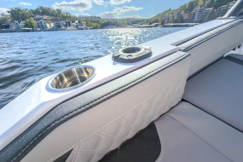 Slide: The Image of Luxury seating on 2027 Monterey Elite 27 OB boat with scenic lake view. - 19