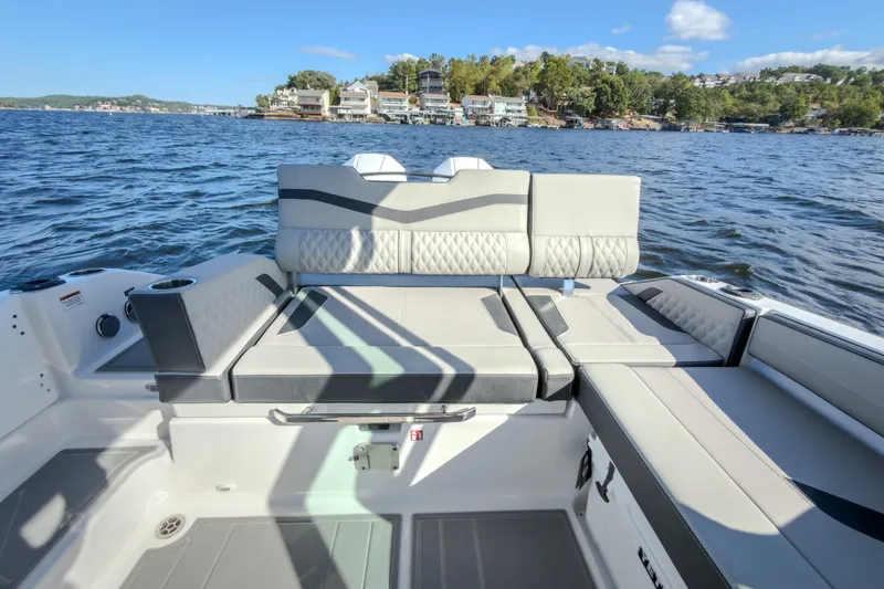 Slide: The Image of Luxurious seating on 2027 Monterey Elite 27 OB boat with scenic lake view. - 17