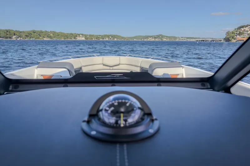 Slide: The Image of View from the helm of a 2027 Monterey Elite 27 OB boat on a lake. - 74