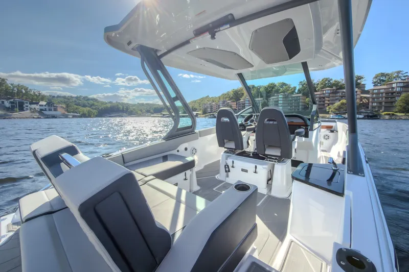 Slide: The Image of 2027 Monterey Elite 27 OB boat interior on a sunny day, with scenic waterfront views. - 23