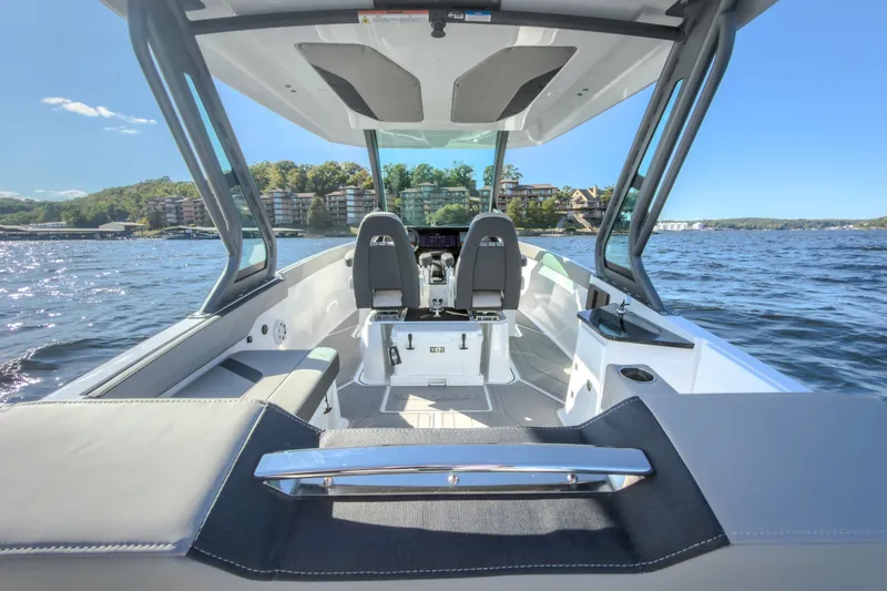 Slide: The Image of 2027 Monterey Elite 27 OB boat interior with sleek seating, open water view, and modern design. - 22