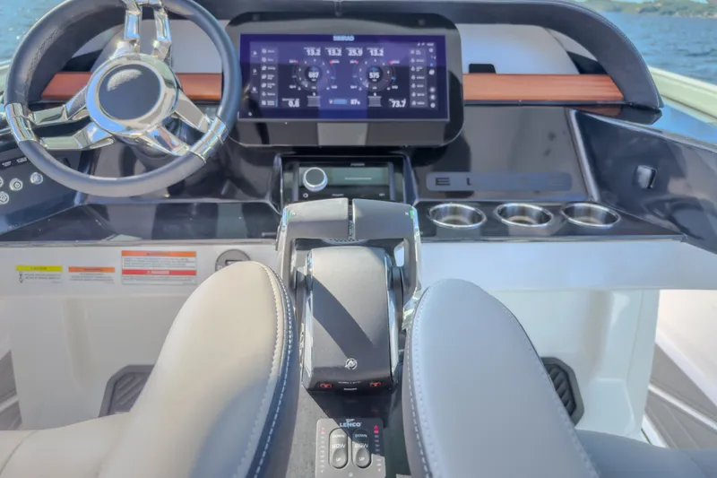 Slide: The Image of Cockpit of 2027 Monterey Elite 27 OB boat with modern steering and digital display. - 47