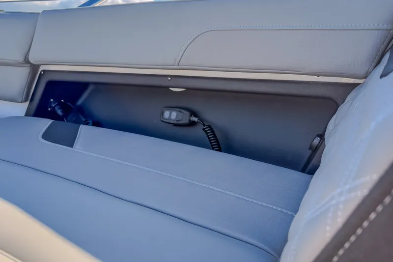 Slide: The Image of Storage compartment in 2027 Monterey Elite 27 OB boat with sleek gray upholstery. - 58