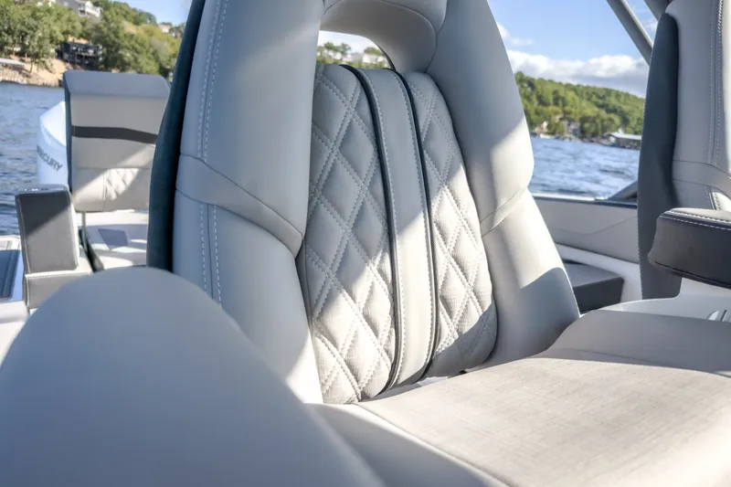 Slide: The Image of Luxurious seating on 2027 Monterey Elite 27 OB boat with quilted upholstery, lake view. - 34
