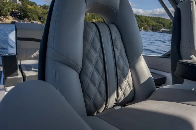 Slide: The Image of Luxurious seating on the 2027 Monterey Elite 27 OB boat, with scenic lake view. - 33
