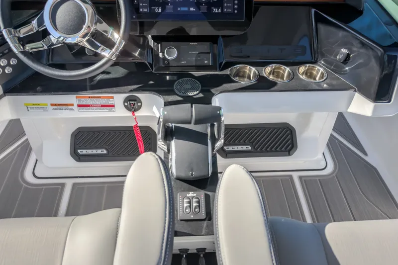 Slide: The Image of Cockpit of 2027 Monterey Elite 27 OB boat with steering wheel and control panel. - 42
