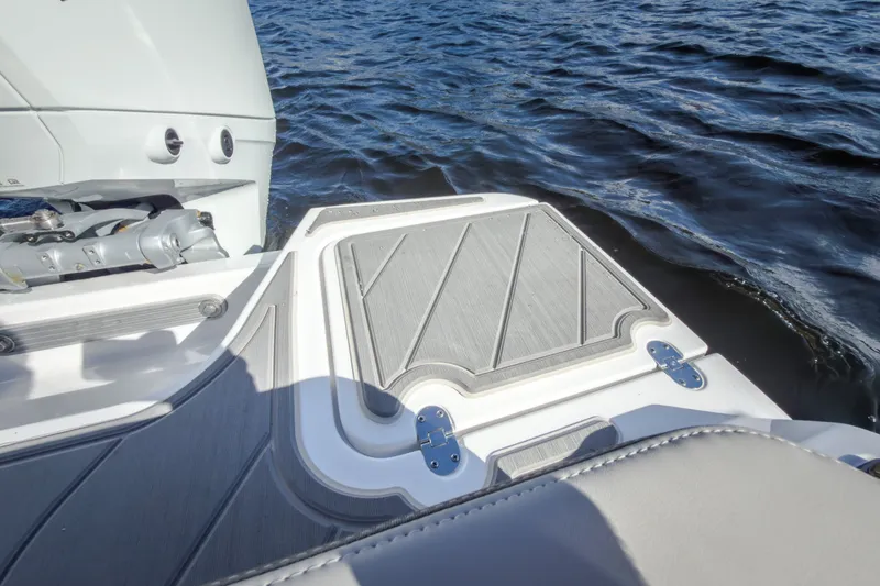 Slide: The Image of 2027 Monterey Elite 27 OB boat deck with motor, on calm water. - 26