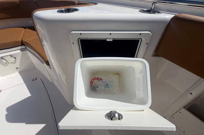 Slide: The Image of 2025 Robalo R302 Center Console boat interior with open storage compartment. - 68