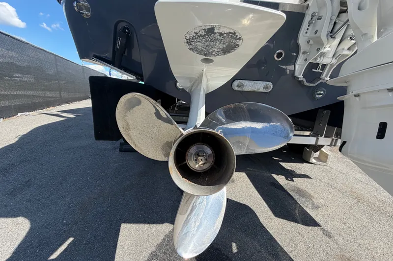 Slide: The Image of 2025 Robalo R302 Center Console boat propeller close-up on pavement. - 7