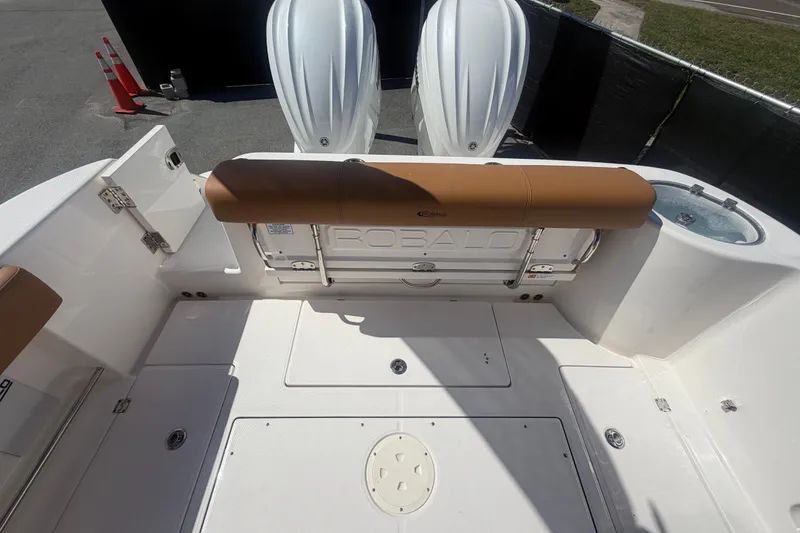 Slide: The Image of 2025 Robalo R302 Center Console boat deck with seating and twin engines. - 79