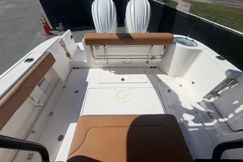 Slide: The Image of 2025 Robalo R302 Center Console boat interior with tan seating and spacious deck layout. - 74