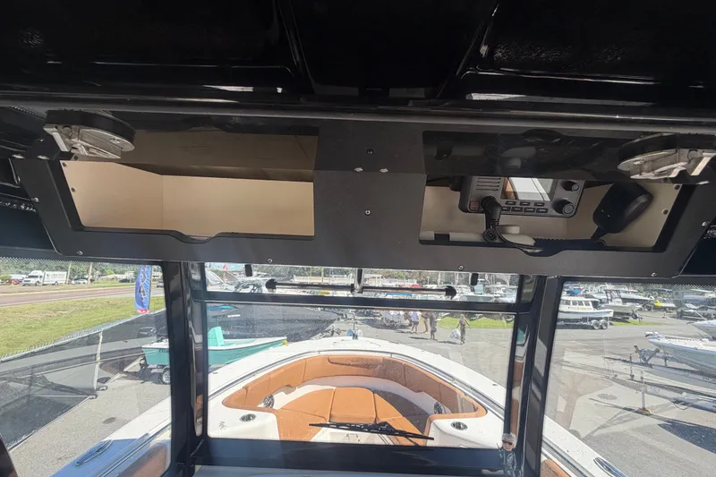 Slide: The Image of 2025 Robalo R302 Center Console boat interior with dashboard and seating area. - 24