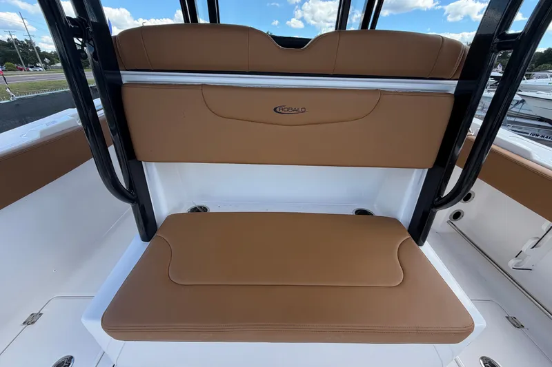 Slide: The Image of 2025 Robalo R302 Center Console boat seating with tan cushions and sleek design. - 21