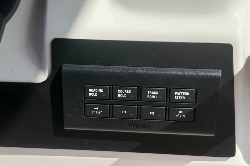 Slide: The Image of Control panel of a 2025 Robalo R302 Center Console boat with Yamaha navigation buttons. - 36