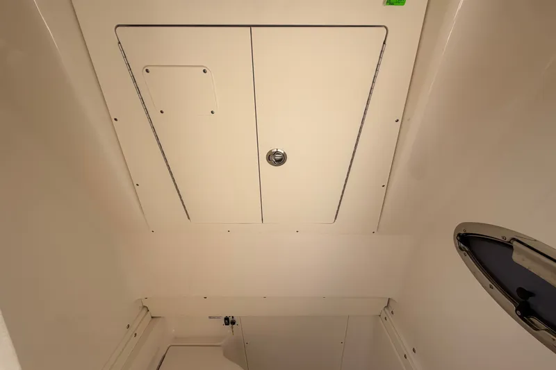 Slide: The Image of Interior view of 2025 Robalo R302 Center Console boat cabin ceiling. - 64