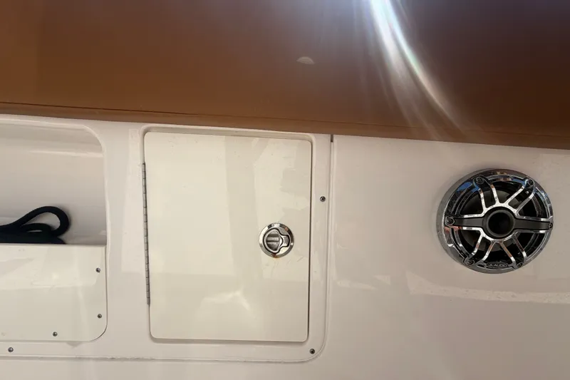 Slide: The Image of 2025 Robalo R302 Center Console boat detail with speaker and storage compartment. - 71