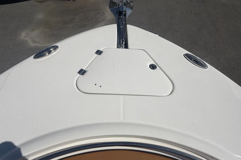 Slide: The Image of 2025 Robalo R302 Center Console boat deck with anchor hatch and stainless steel fittings. - 54