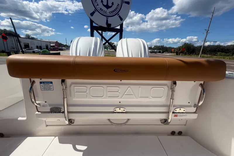 Slide: The Image of 2025 Robalo R302 Center Console boat with tan seating and branded backrest. - 82