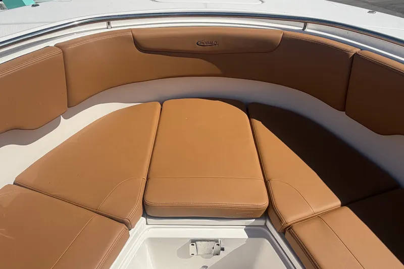Slide: The Image of 2025 Robalo R302 Center Console boat with tan cushioned seating area. - 45