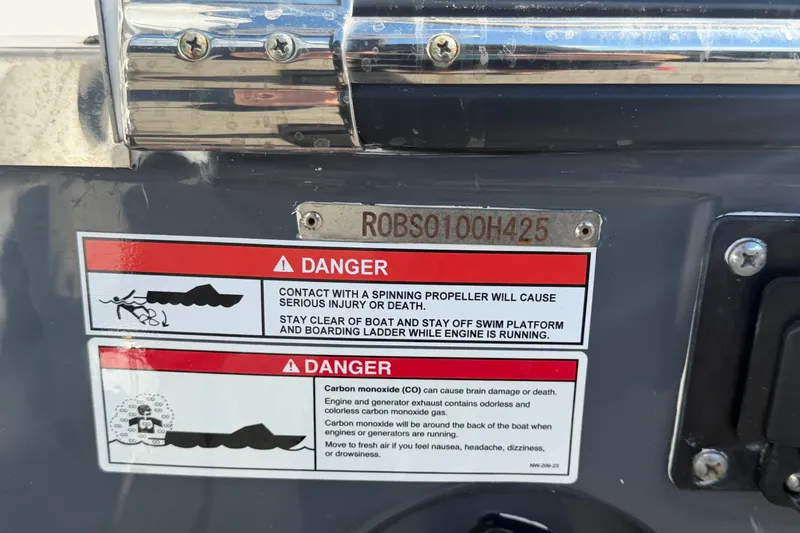 Slide: The Image of Warning labels on 2025 Robalo R302 Center Console boat, emphasizing safety precautions. - 89