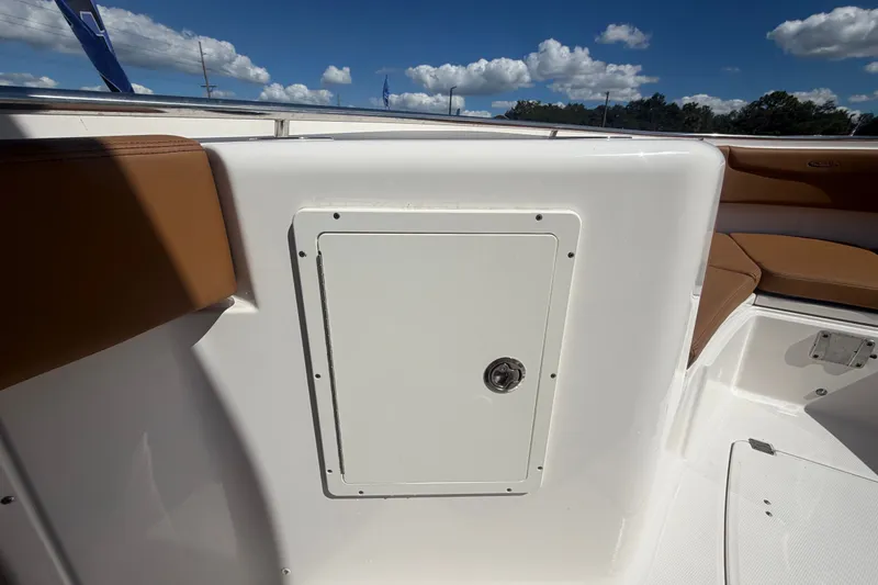 Slide: The Image of 2025 Robalo R302 Center Console boat interior with storage compartment and cushioned seating. - 39