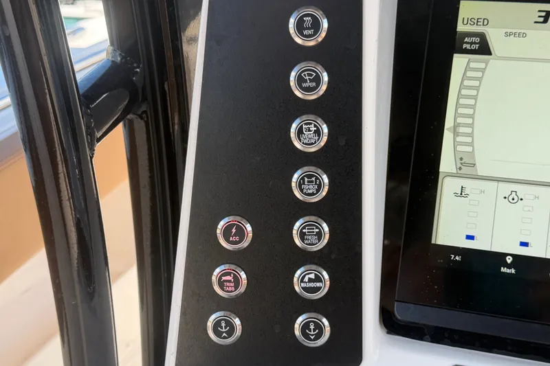 Slide: The Image of Control panel of 2025 Robalo R302 Center Console boat with various function buttons. - 31