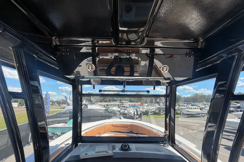 Slide: The Image of Interior view of 2025 Robalo R302 Center Console boat at a marina. - 23