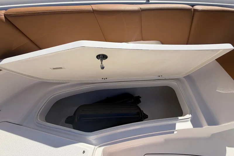 Slide: The Image of Open storage compartment on 2025 Robalo R302 Center Console boat. - 50