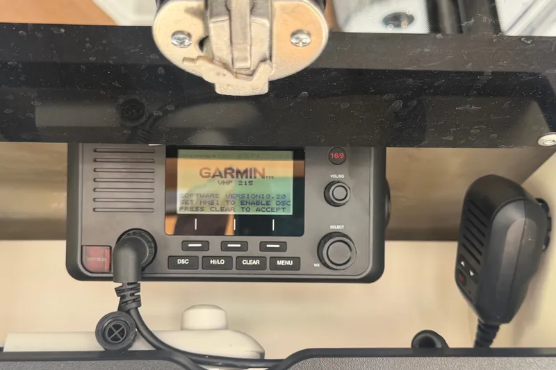 Slide: The Image of Garmin VHF 215 radio on 2025 Robalo R302 Center Console boat dashboard. - 25