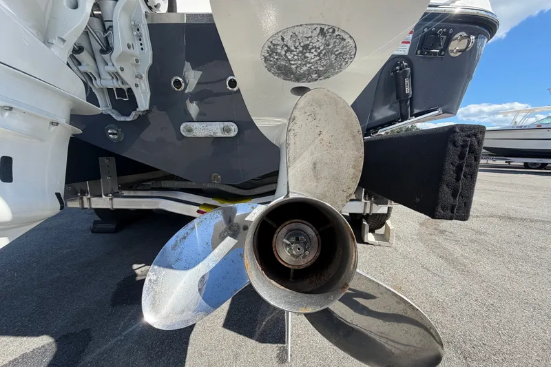Slide: The Image of Propeller of 2025 Robalo R302 Center Console boat on a trailer, close-up view. - 6