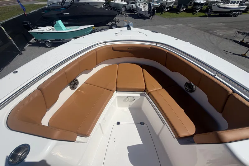 Slide: The Image of 2025 Robalo R302 Center Console boat with tan seating and spacious deck. - 41