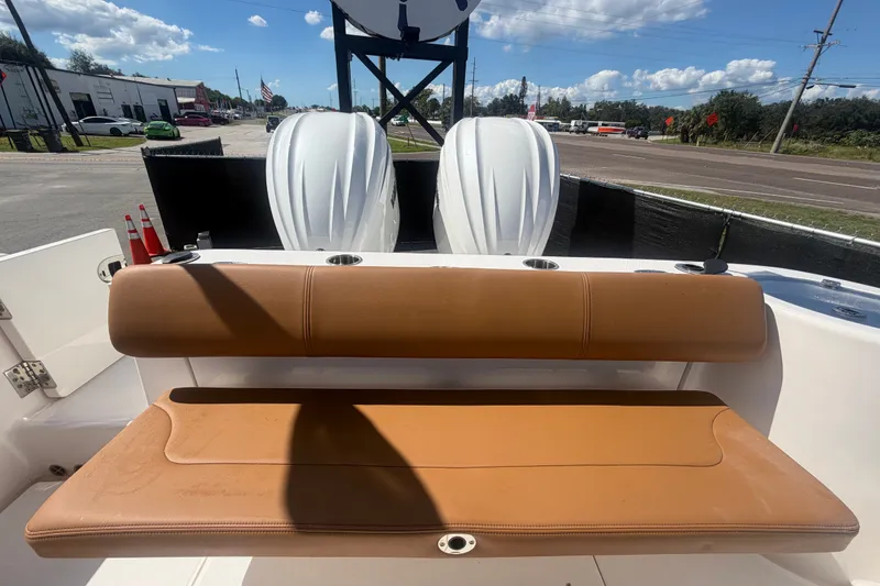 Slide: The Image of 2025 Robalo R302 Center Console boat with tan seating and dual outboard engines. - 83