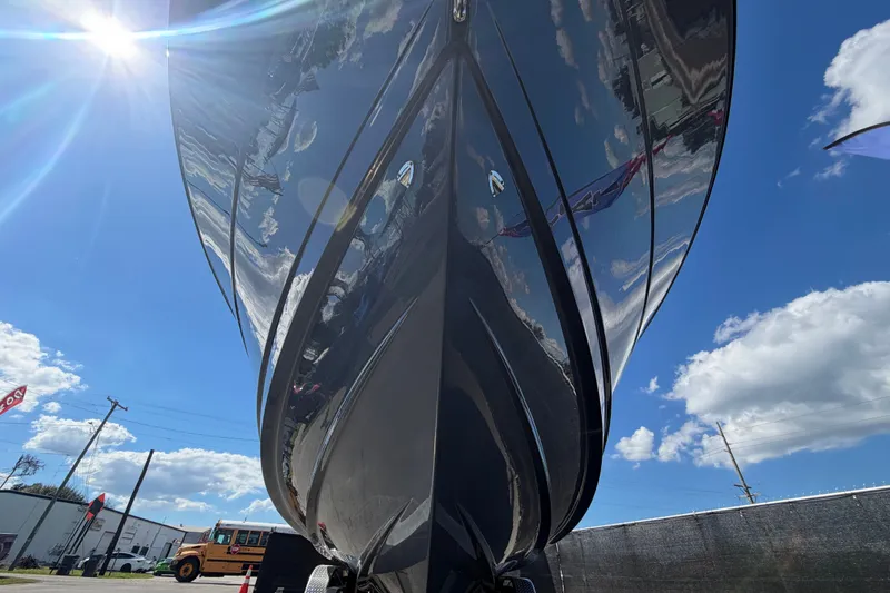 Slide: The Image of 2025 Robalo R302 Center Console boat under bright blue sky and sun. - 14