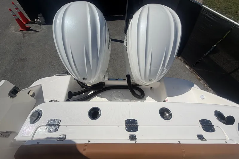 Slide: The Image of 2025 Robalo R302 Center Console boat with dual outboard engines, viewed from above. - 87