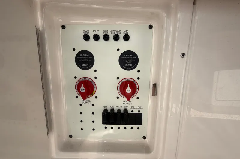 Slide: The Image of Control panel of 2025 Robalo R302 Center Console boat, featuring power switches and digital relays. - 72