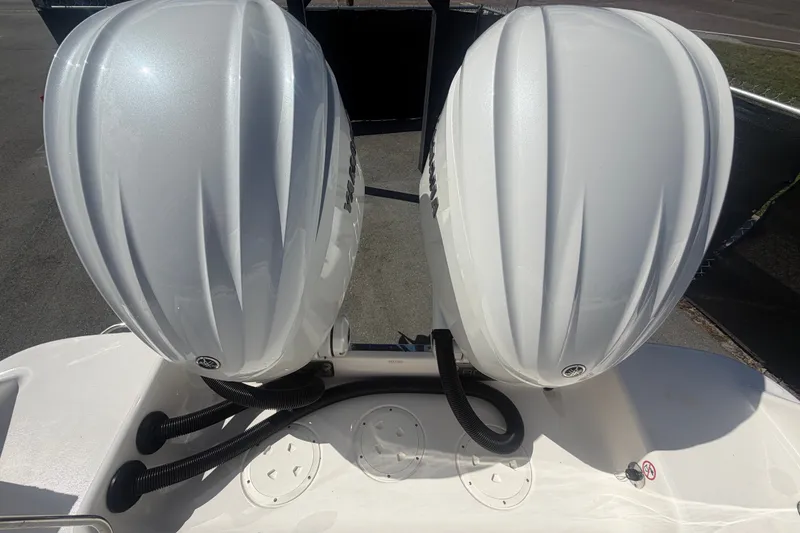 Slide: The Image of 2025 Robalo R302 Center Console with dual outboard engines, rear view. - 88