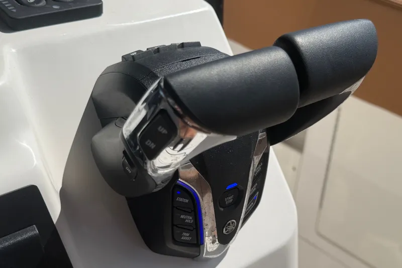 Slide: The Image of Throttle controls of the 2025 Robalo R302 Center Console boat, featuring modern design. - 37