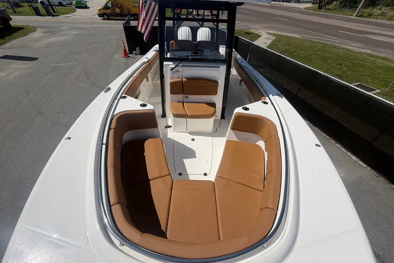 Slide: The Image of 2025 Robalo R302 Center Console boat with tan seating and sleek design. - 57