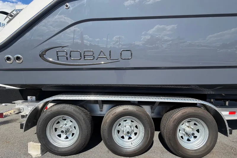 Slide: The Image of 2025 Robalo R302 Center Console boat on a trailer, side view. - 94